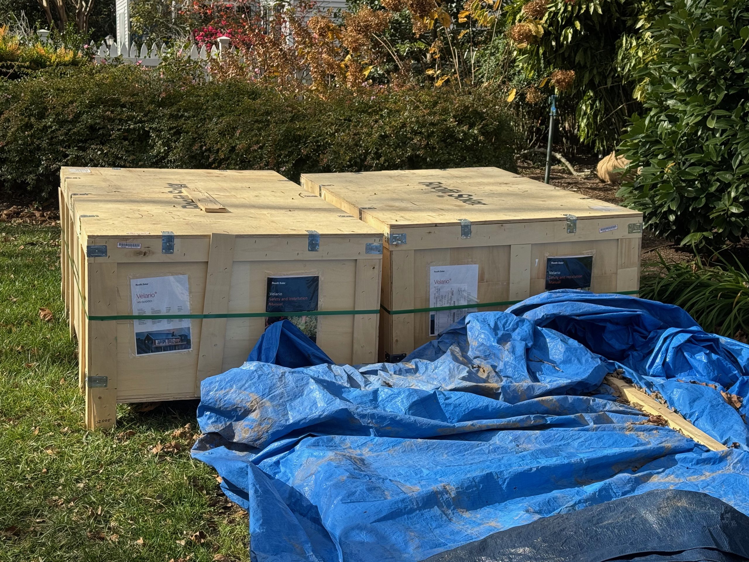 Roofit.Solar Velario shipping crates delivered on a U.S. lawn