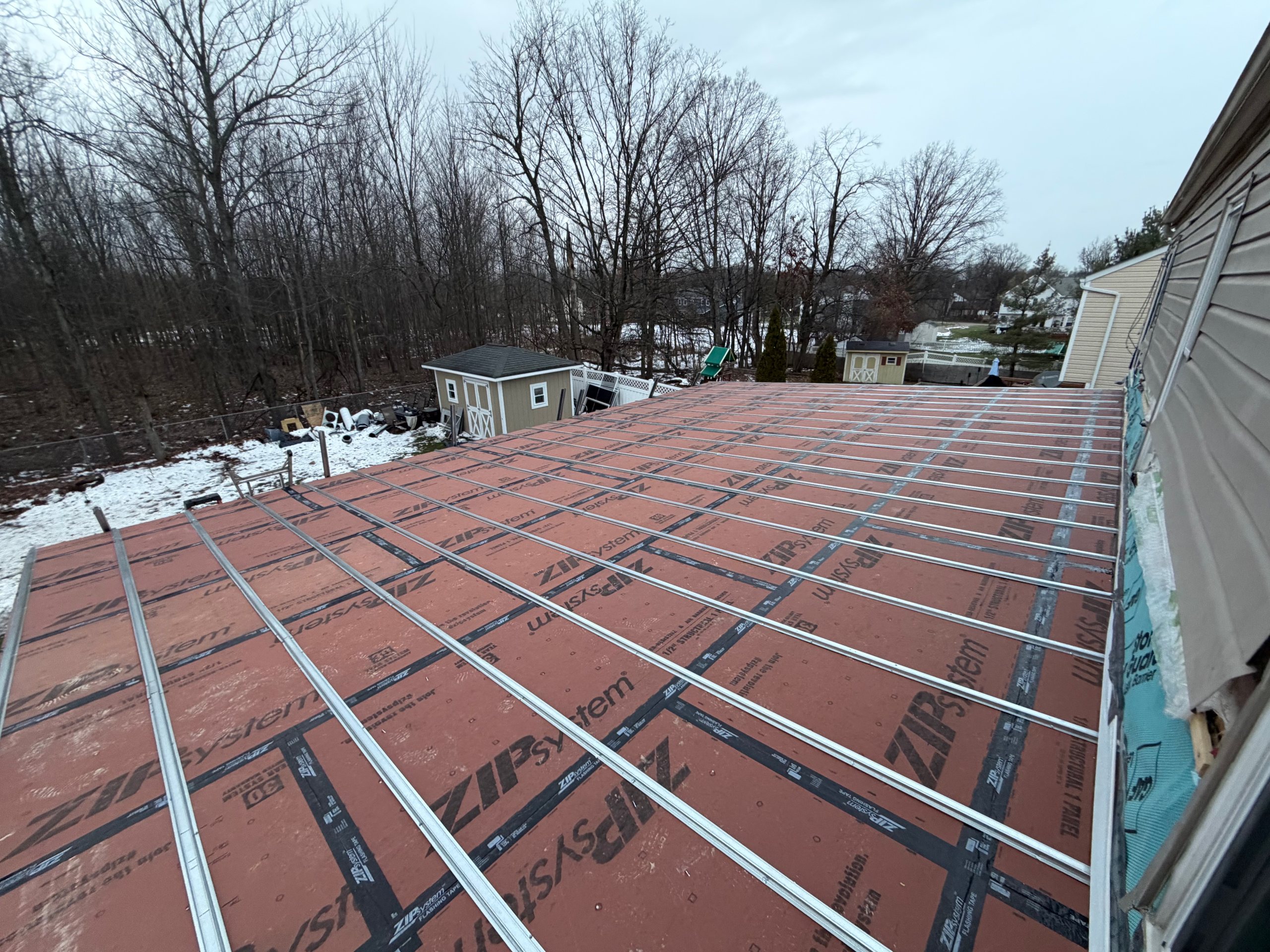 ArcEdge crew installing roof battens over underlayment during an American winter