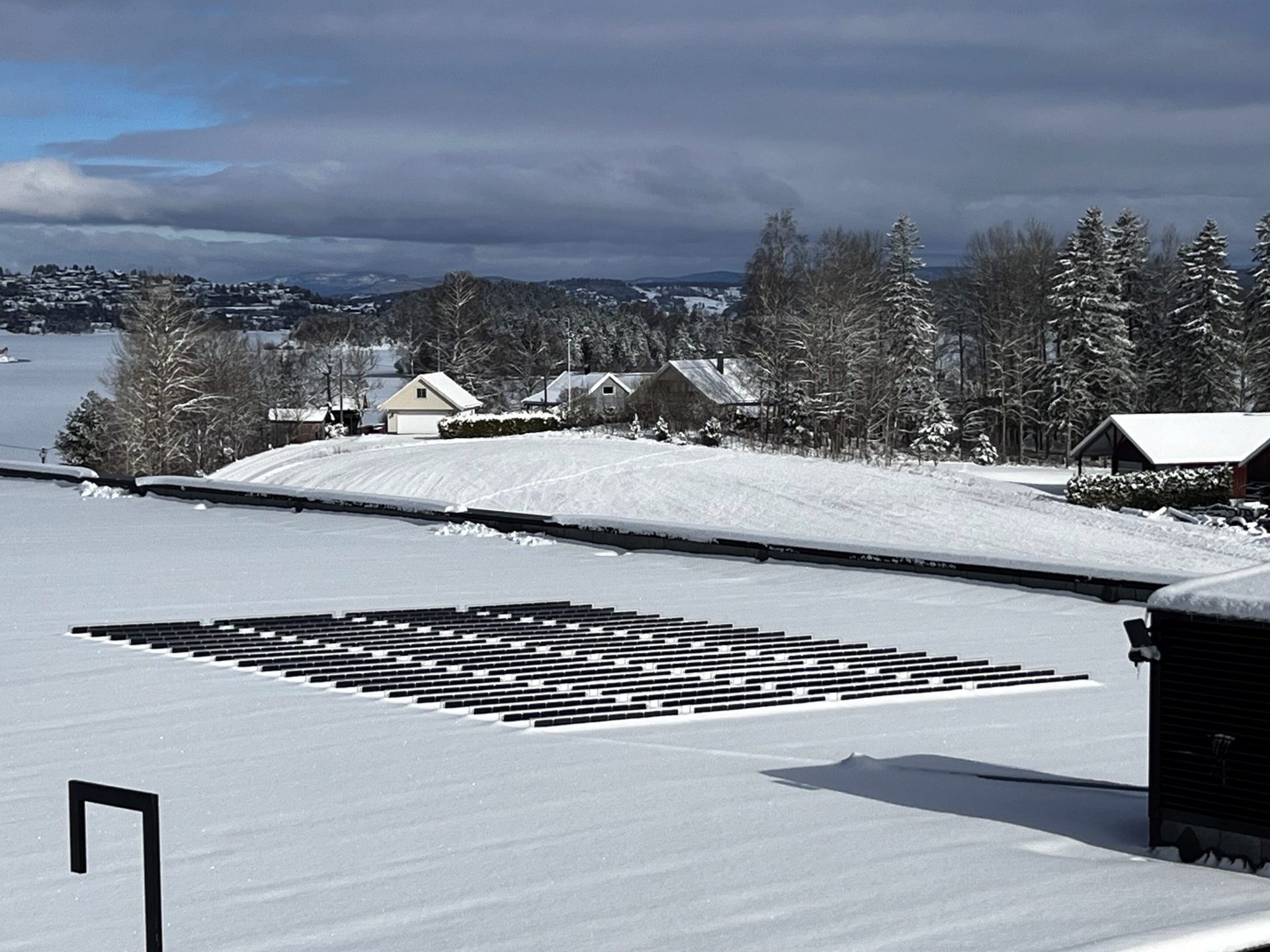 Over Easy Solar vertical units shedding snow on a roof in Norway