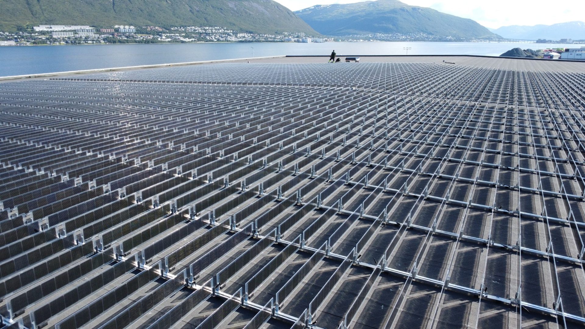 Rows of Over Easy Solar vertical bifacial units on the Tromsoterminalen roof in Tromso, Norway